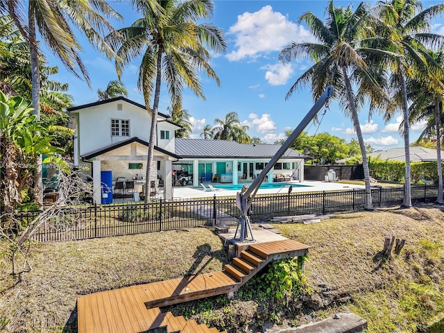 back of property featuring a fenced backyard, a patio, and stucco siding
