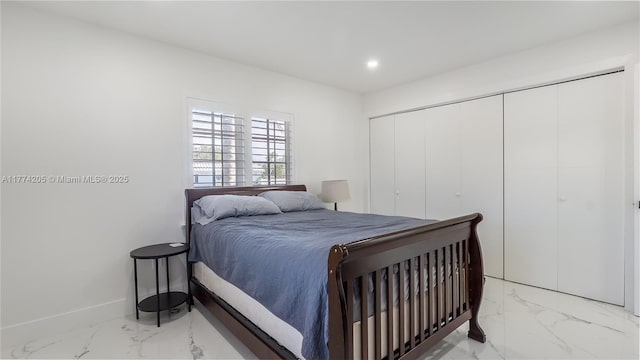 bedroom with light marble finish floors, recessed lighting, baseboards, and a closet
