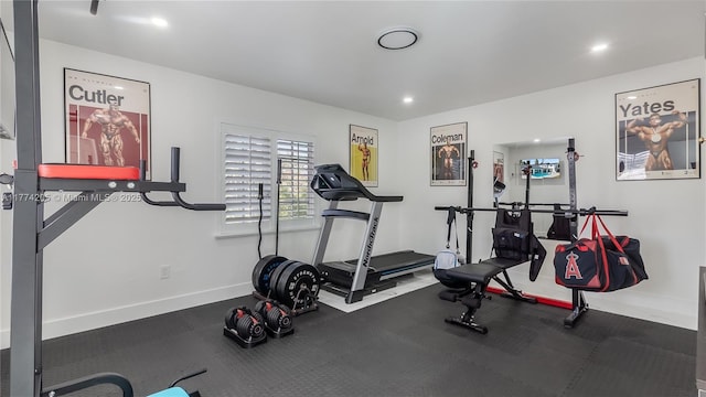 workout room featuring baseboards and recessed lighting