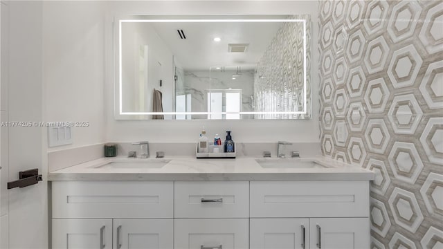 bathroom with double vanity and a stall shower