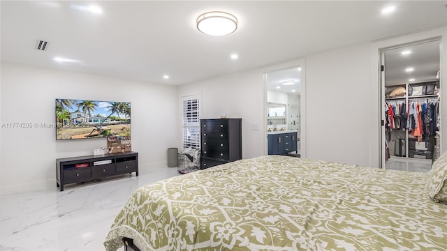 bedroom featuring recessed lighting, ensuite bathroom, a spacious closet, marble finish flooring, and baseboards