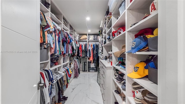 spacious closet with light marble finish floors