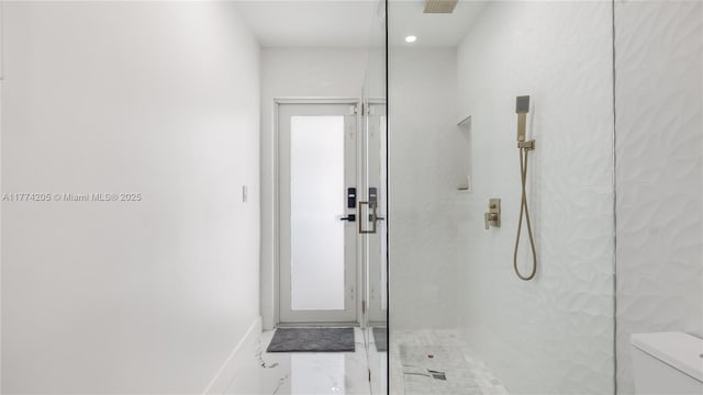 full bath with toilet, a walk in shower, marble finish flooring, and baseboards