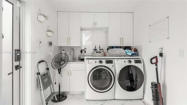 washroom with washer and clothes dryer, marble finish floors, and cabinet space