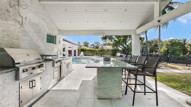 view of patio / terrace featuring grilling area, exterior kitchen, and a fenced backyard