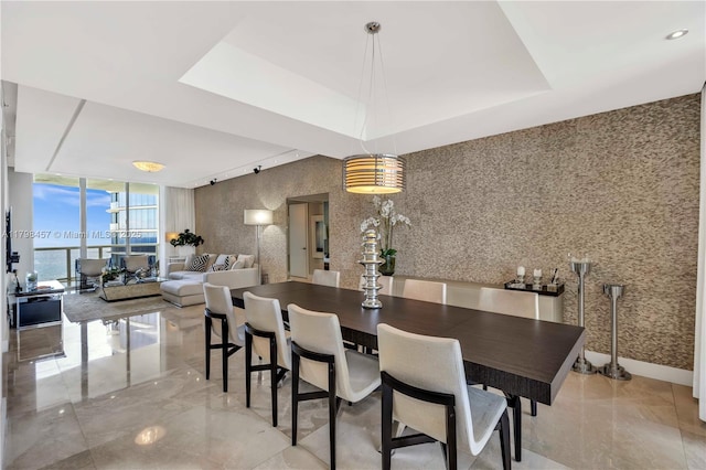 15811 Collins Ave Unit 2506, Sunny Isles Beach, FL 33160 - dining space with a wall of windows, marble tiled flooring, and a tray ceiling