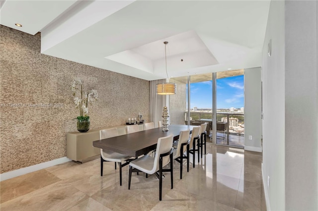 15811 Collins Ave Unit 2506, Sunny Isles Beach, FL 33160 - dining space with floor to ceiling windows, baseboards, a tray ceiling, and recessed lighting