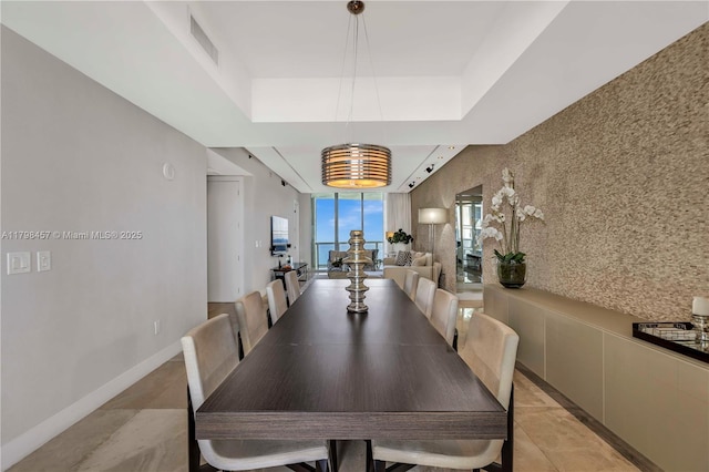 15811 Collins Ave Unit 2506, Sunny Isles Beach, FL 33160 - dining room with a raised ceiling and light tile patterned flooring