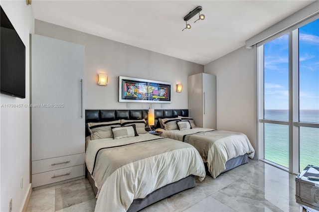 15811 Collins Ave Unit 2506, Sunny Isles Beach, FL 33160 - bedroom featuring multiple windows and a water view