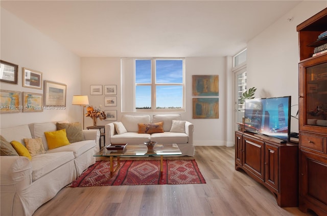 living room featuring light wood-style flooring and baseboards