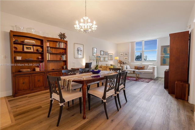 dining area featuring a chandelier and light wood-style flooring