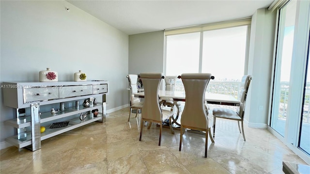 1745 E Hallandale Beach Blvd Unit 2007W, Hallandale Beach, FL 33009 - dining room featuring healthy amount of natural light, baseboards, and stone finish floors