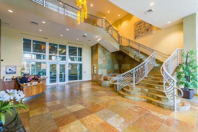 1745 E Hallandale Beach Blvd Unit 2007W, Hallandale Beach, FL 33009 - stairs with a high ceiling, stone tile flooring, recessed lighting, and french doors