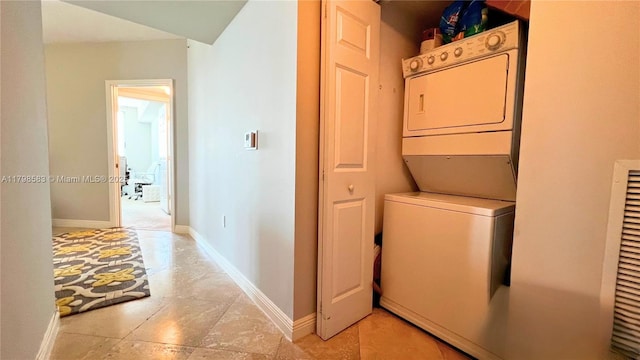 1745 E Hallandale Beach Blvd Unit 2007W, Hallandale Beach, FL 33009 - washroom with stacked washing machine and dryer and baseboards