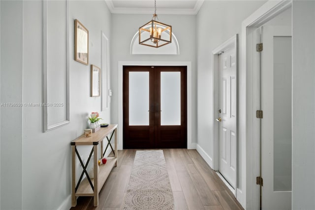 1199 NW 166th Ave, Pembroke Pines, FL 33028 - foyer featuring a chandelier, baseboards, wood finished floors, ornamental molding, and french doors