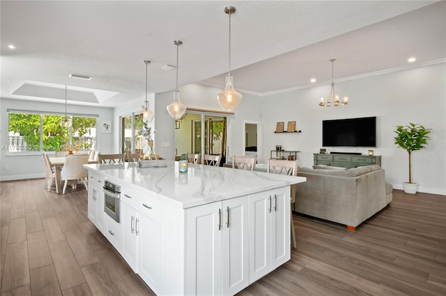 1199 NW 166th Ave, Pembroke Pines, FL 33028 - kitchen with oven, dark wood-style floors, white cabinetry, a chandelier, and light stone countertops