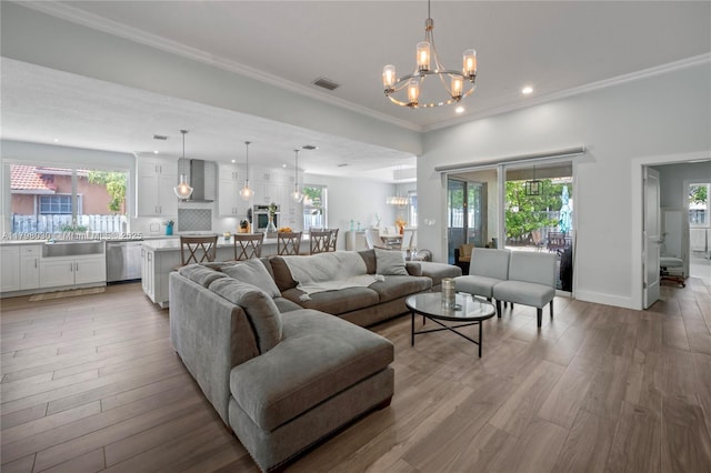 1199 NW 166th Ave, Pembroke Pines, FL 33028 - living area with a chandelier, plenty of natural light, wood finished floors, recessed lighting, and ornamental molding