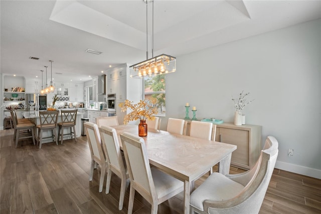 1199 NW 166th Ave, Pembroke Pines, FL 33028 - dining area featuring a chandelier, dark wood-type flooring, baseboards, a tray ceiling, and recessed lighting