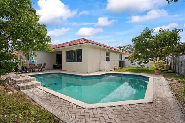 1199 NW 166th Ave, Pembroke Pines, FL 33028 - back of property with a fenced backyard, a patio area, stucco siding, and a tile roof