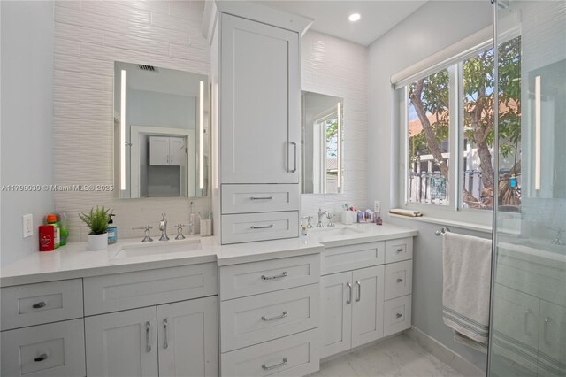 1199 NW 166th Ave, Pembroke Pines, FL 33028 - bathroom with double vanity, tasteful backsplash, marble look tiles, a stall shower, and baseboards