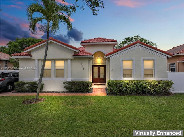 1199 NW 166th Ave, Pembroke Pines, FL 33028 - mediterranean / spanish-style home featuring a tiled roof, a front yard, french doors, and stucco siding