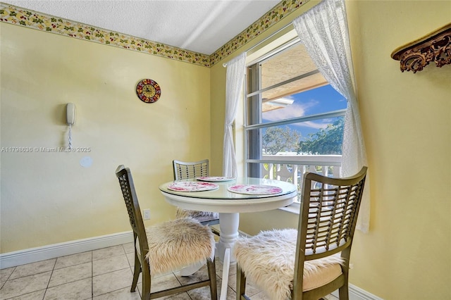 1450 NW 18th Ave Unit 203, Delray Beach, FL 33445 - tiled dining space with baseboards and a textured ceiling