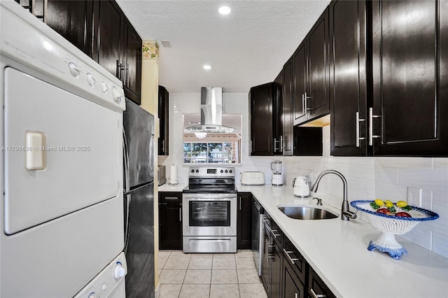 1450 NW 18th Ave Unit 203, Delray Beach, FL 33445 - kitchen with appliances with stainless steel finishes, a sink, stacked washing machine and dryer, extractor fan, and light countertops
