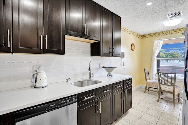 1450 NW 18th Ave Unit 203, Delray Beach, FL 33445 - kitchen with dishwasher, a sink, a textured ceiling, light countertops, and baseboards