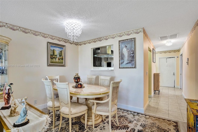 1450 NW 18th Ave Unit 203, Delray Beach, FL 33445 - dining room featuring a textured ceiling, baseboards, light tile patterned floors, and a chandelier