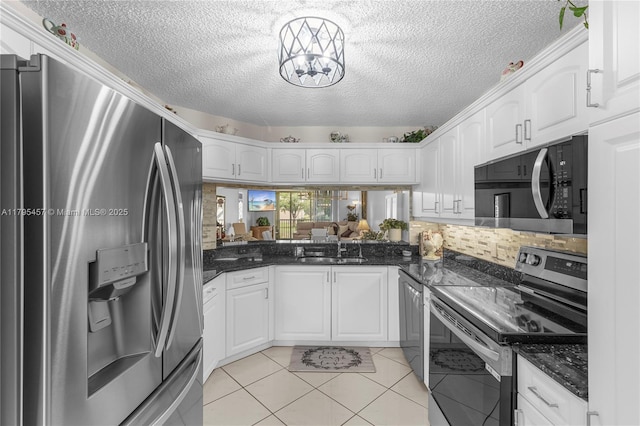 2541 N Nob Hill Rd Unit 205, Sunrise, FL 33322 - kitchen with appliances with stainless steel finishes, a sink, a textured ceiling, white cabinetry, and backsplash