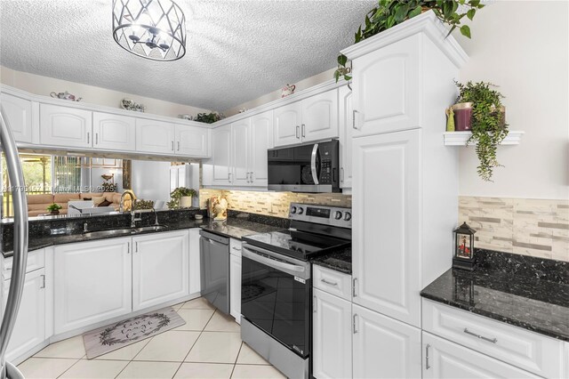 2541 N Nob Hill Rd Unit 205, Sunrise, FL 33322 - kitchen featuring stainless steel appliances, a sink, backsplash, white cabinets, and a textured ceiling