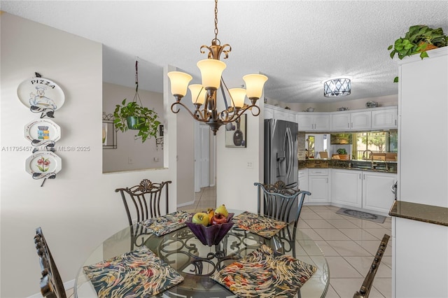 2541 N Nob Hill Rd Unit 205, Sunrise, FL 33322 - dining space with a chandelier, light tile patterned flooring, a textured ceiling, and baseboards