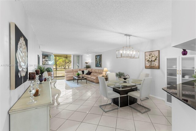 2541 N Nob Hill Rd Unit 205, Sunrise, FL 33322 - dining area featuring light tile patterned flooring, a textured ceiling, a chandelier, and baseboards