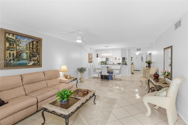 2541 N Nob Hill Rd Unit 205, Sunrise, FL 33322 - living area featuring ceiling fan, a textured ceiling, light tile patterned floors, baseboards, and a chandelier