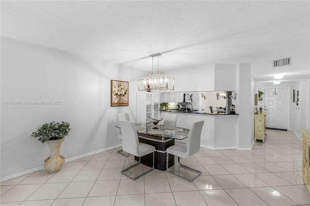 2541 N Nob Hill Rd Unit 205, Sunrise, FL 33322 - dining area with a textured ceiling, baseboards, a chandelier, and light tile patterned flooring
