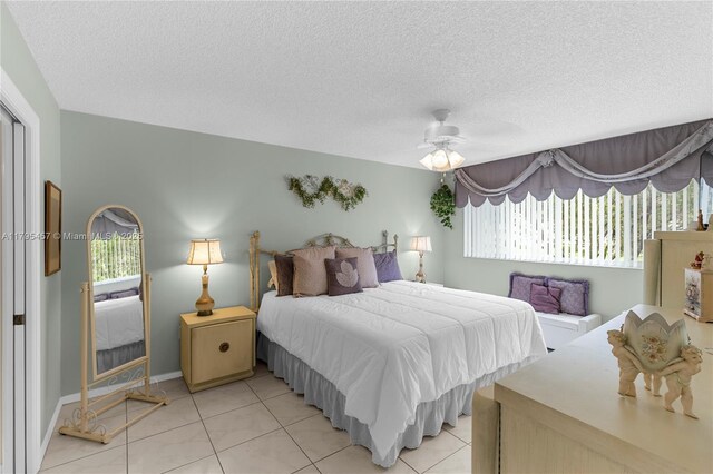 2541 N Nob Hill Rd Unit 205, Sunrise, FL 33322 - bedroom featuring multiple windows, light tile patterned floors, a textured ceiling, and ceiling fan