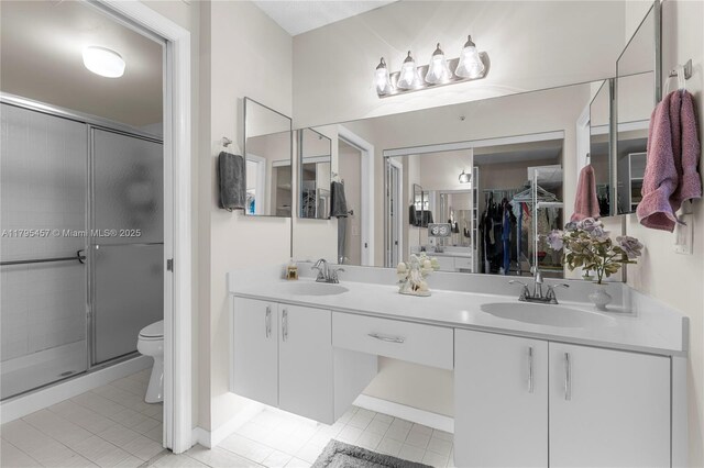 2541 N Nob Hill Rd Unit 205, Sunrise, FL 33322 - full bathroom with a stall shower, toilet, tile patterned flooring, and double vanity