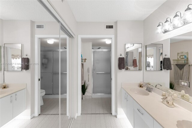 2541 N Nob Hill Rd Unit 205, Sunrise, FL 33322 - full bathroom with a shower stall, a textured ceiling, tile patterned flooring, vanity, and toilet