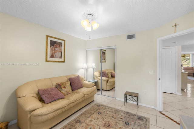 2541 N Nob Hill Rd Unit 205, Sunrise, FL 33322 - living room featuring ceiling fan, light tile patterned floors, a textured ceiling, and baseboards