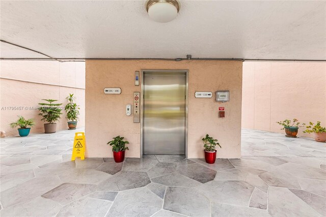 2541 N Nob Hill Rd Unit 205, Sunrise, FL 33322 - property entrance featuring elevator and stucco siding