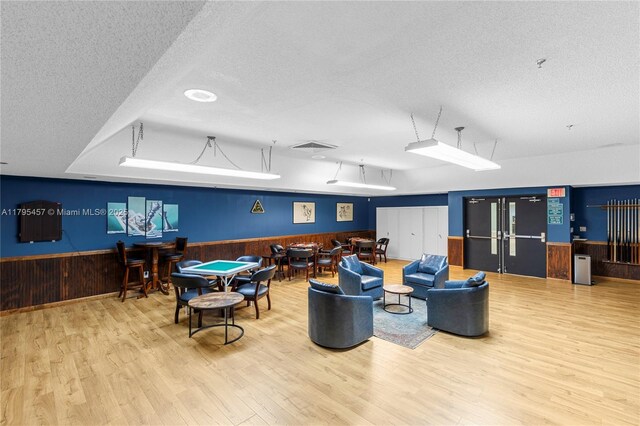 2541 N Nob Hill Rd Unit 205, Sunrise, FL 33322 - game room with a textured ceiling, wainscoting, wood finished floors, and wood walls
