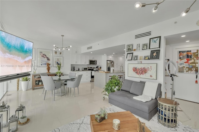 living area featuring light tile patterned floors, a chandelier, and recessed lighting