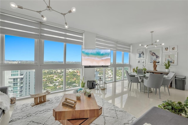 tiled living room featuring plenty of natural light, a chandelier, and a wall of windows