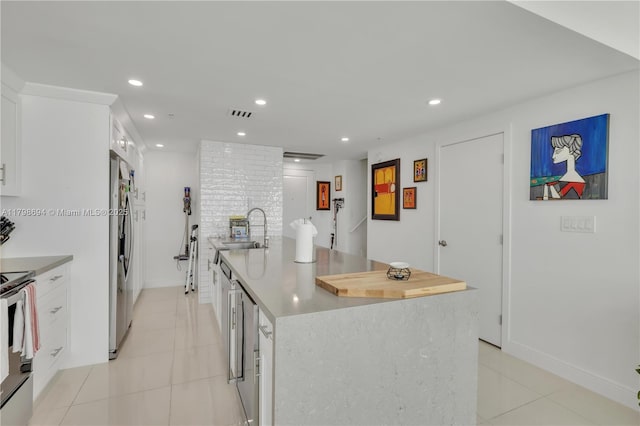 kitchen with a sink, light tile patterned floors, range with electric stovetop, stainless steel fridge with ice dispenser, and recessed lighting