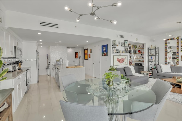 dining area featuring a chandelier, light tile patterned flooring, and recessed lighting