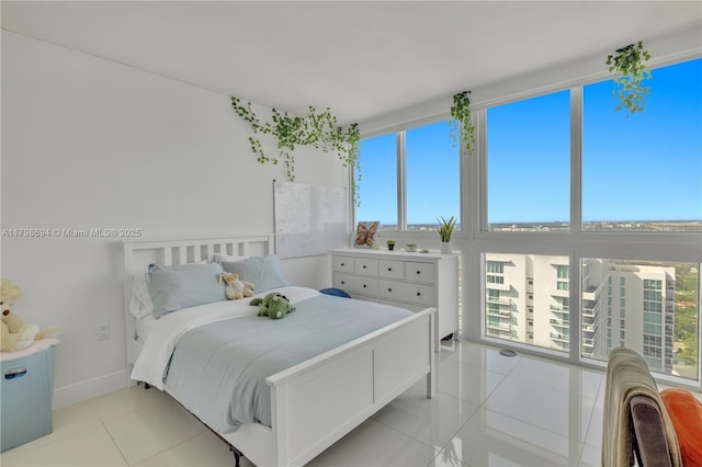 bedroom featuring light tile patterned flooring and baseboards