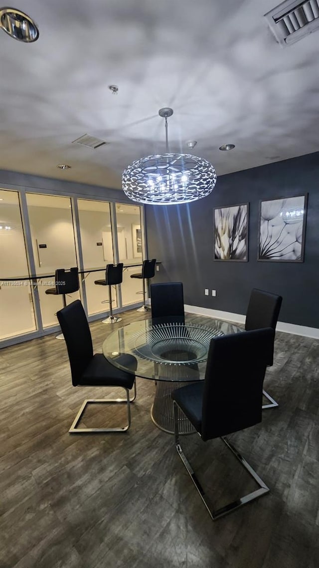 dining area featuring baseboards, an office area, and wood finished floors