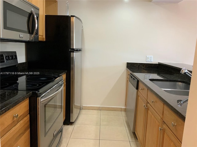 8180 Geneva Ct Unit 224, Doral, FL 33166 - kitchen featuring stainless steel appliances, a sink, light tile patterned floors, baseboards, and dark stone counters
