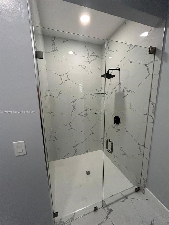 full bathroom featuring a marble finish shower, marble look tile flooring, baseboards, and recessed lighting
