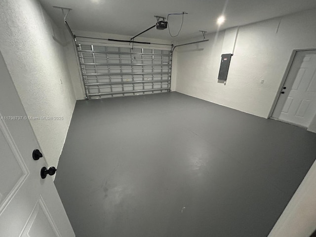 garage featuring a garage door opener and electric panel
